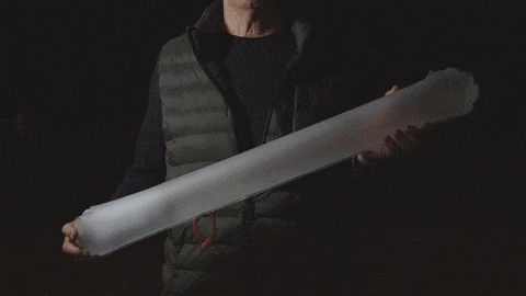 GIF showing a man holding the Solar Beam and turning it on and off in the dark