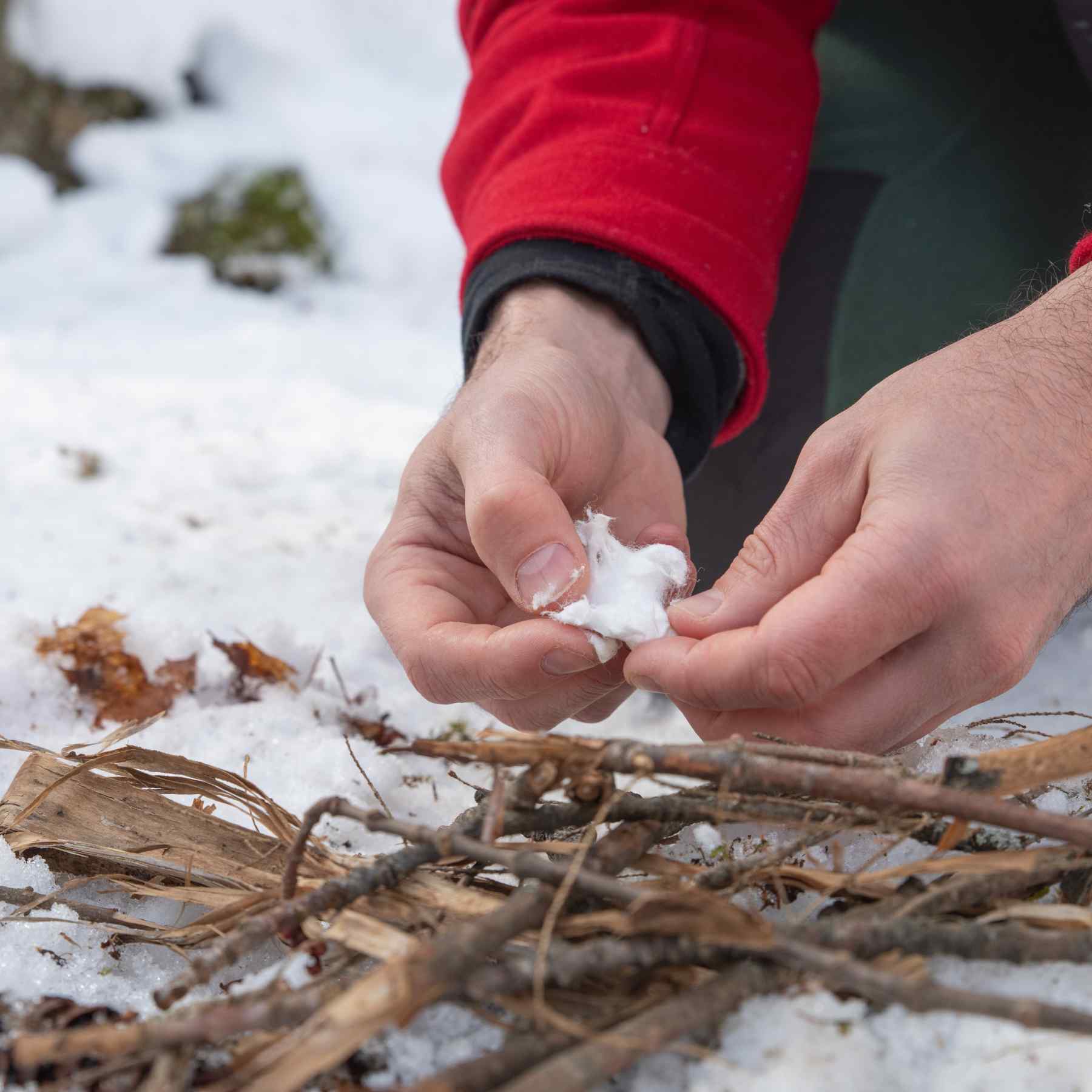 Tinder Quik pulling apart Tinder Quik over twigs on snow