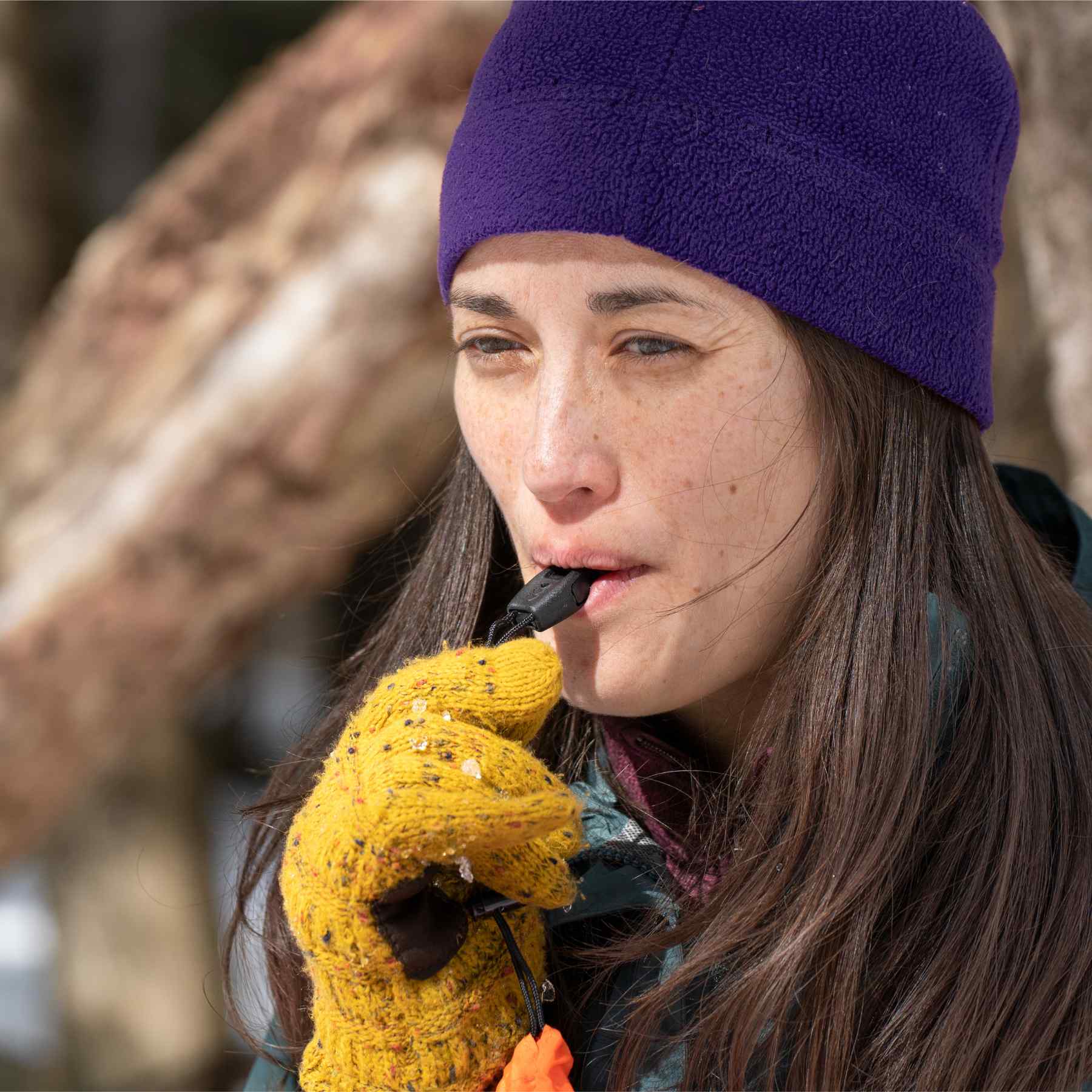 Emergency Bivvy with Rescue Whistle - OD Green woman in blue hat blowing whistle on bivvy