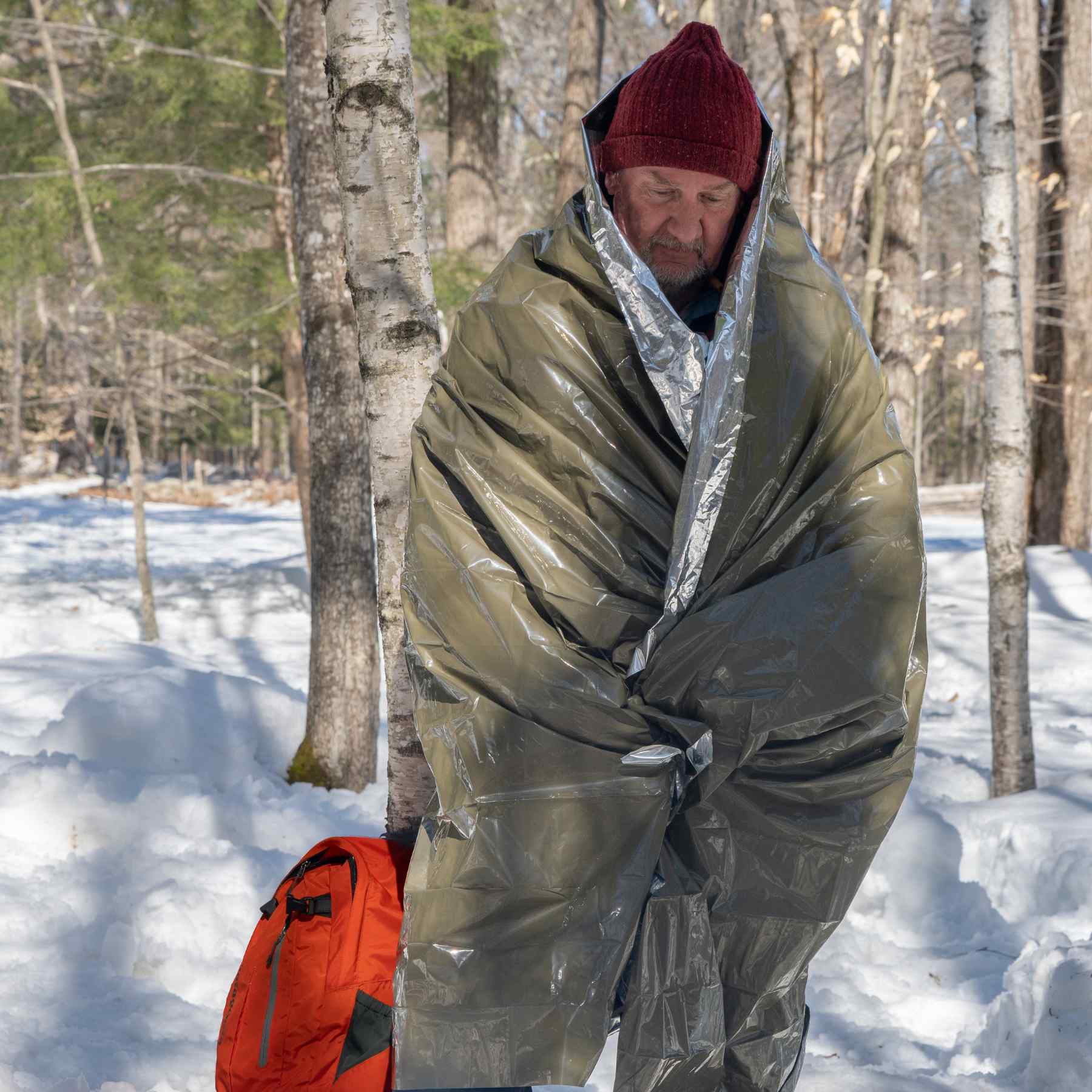 Heavy Duty Emergency Blanket man wrapped in blanket in snowy background