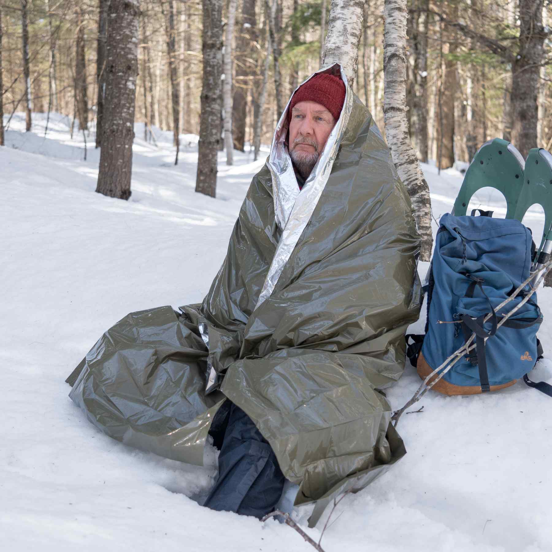 Heavy Duty Emergency Blanket man wrapped in blanket in snow