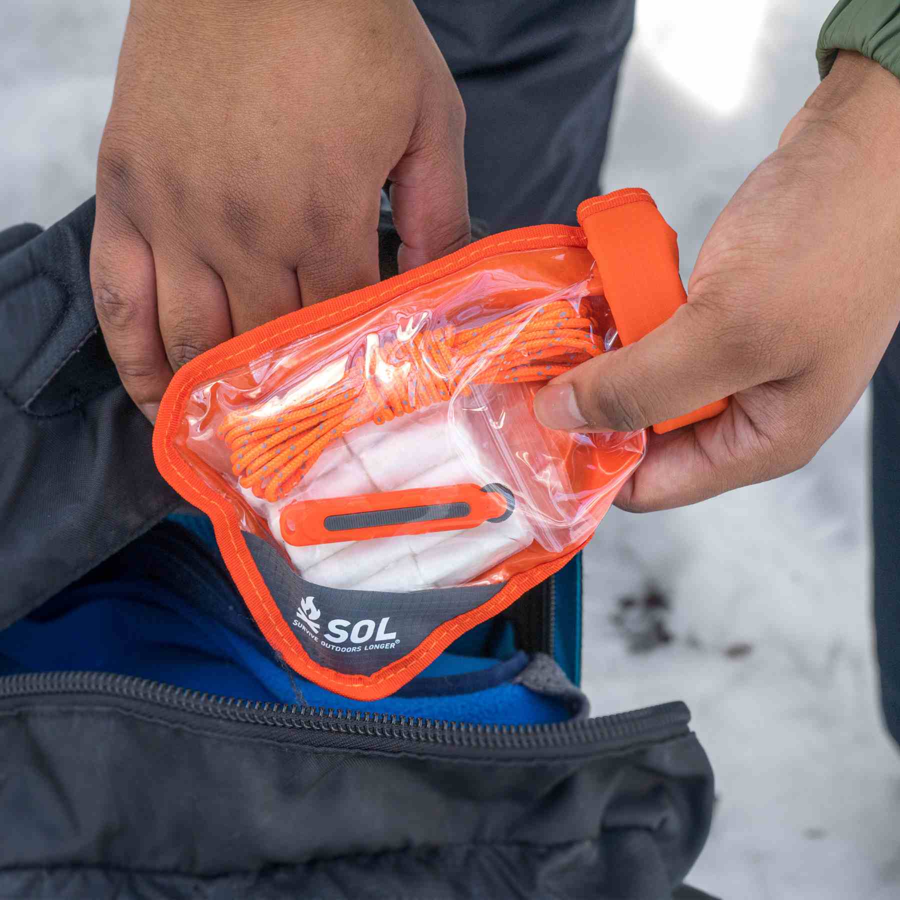 Fire Lite Kit in Dry Bag pulling kit from black backpack
