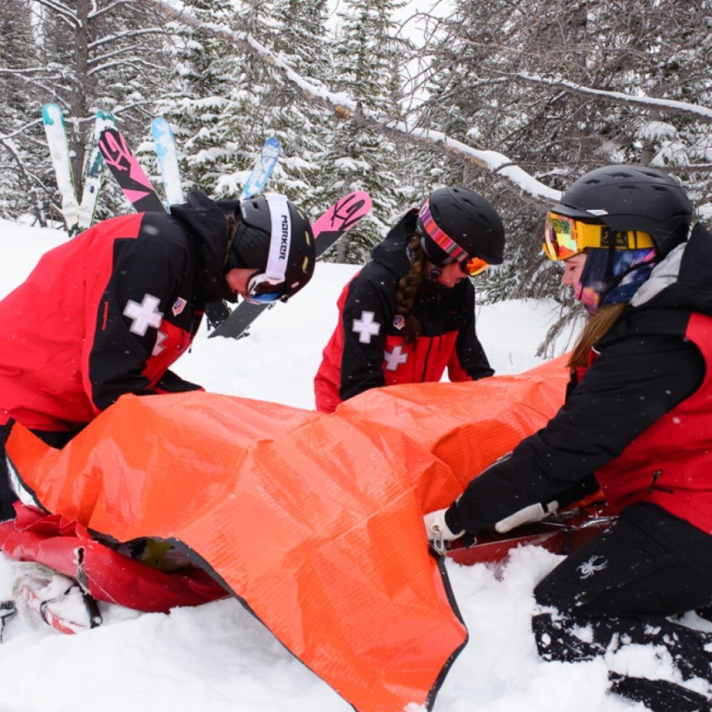 All Season Blanket ski patrol wrapping patient in blanket