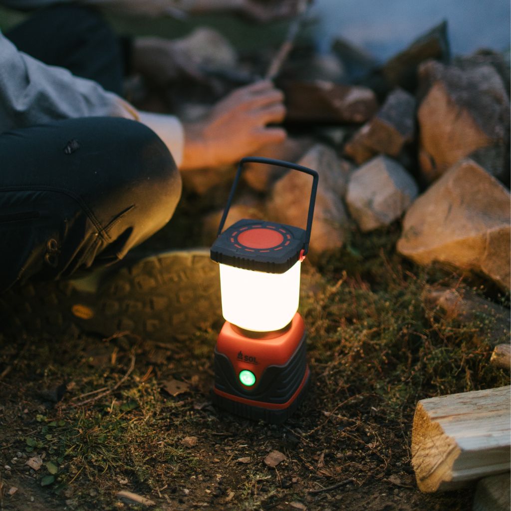 Camp Lantern Recharge with Power Bank lit lantern sitting on ground