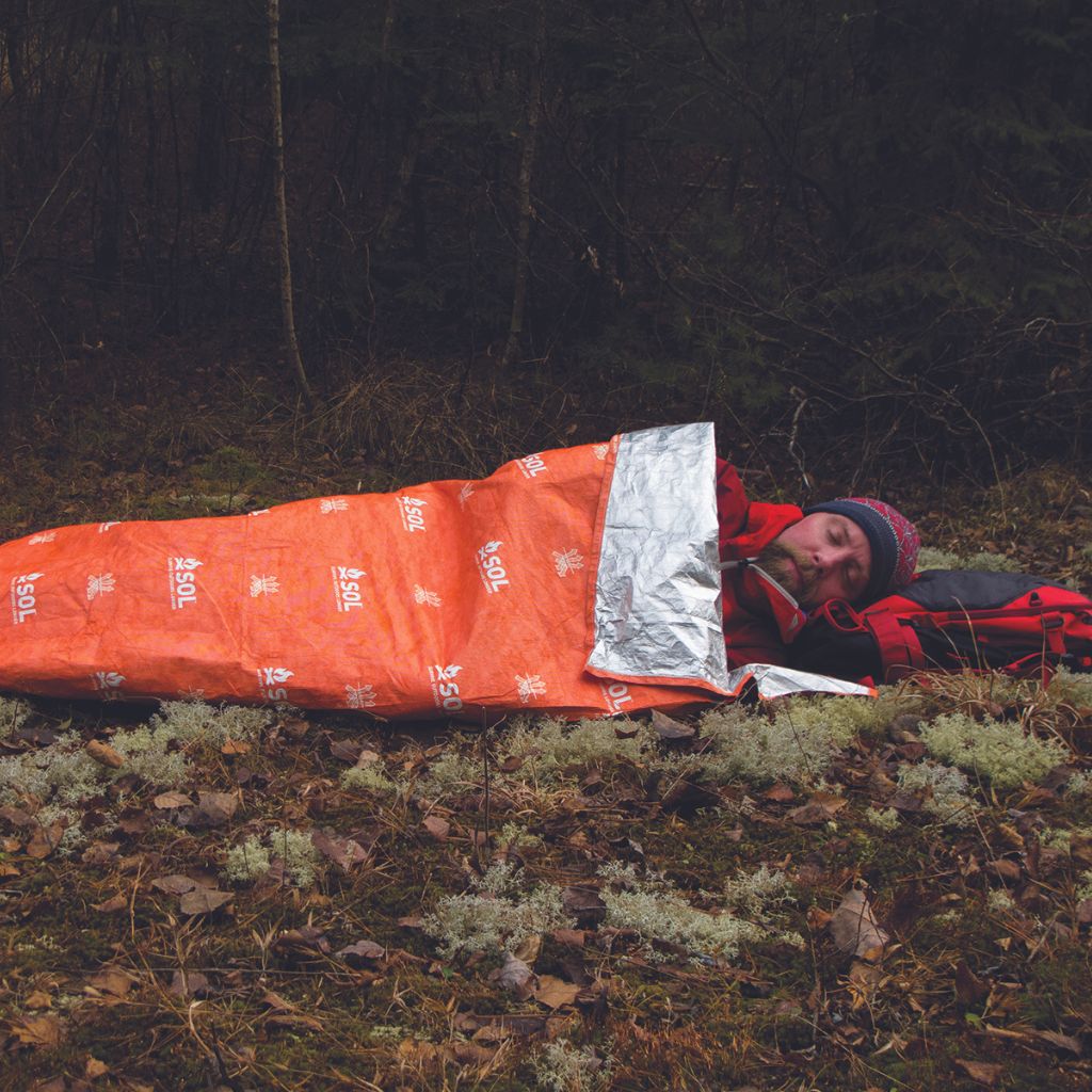 Escape Lite Bivvy man laying on ground in bivvy