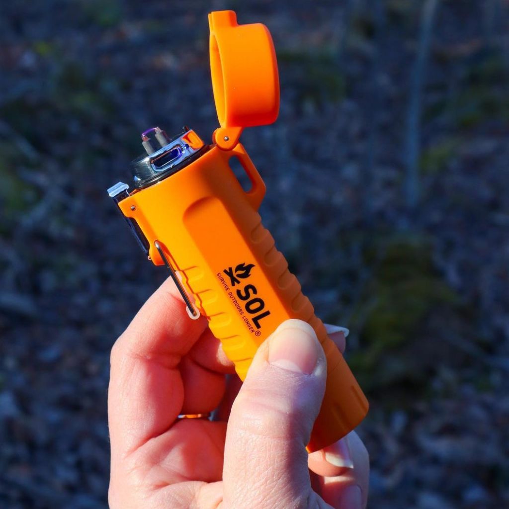 Fire Lite Fuel-Free Lighter holding in hand in the outdoors