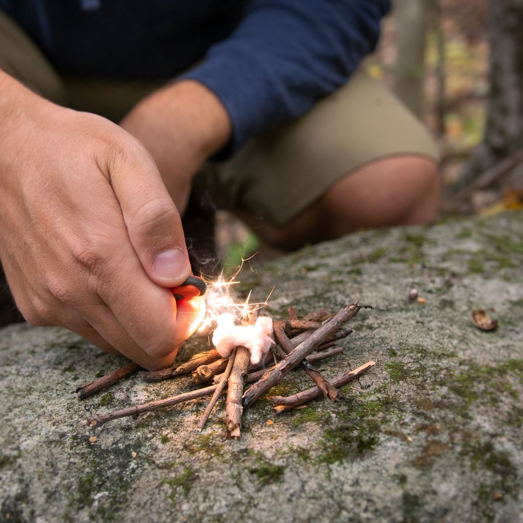 Fire Lite Micro Sparker using sparker to light fire on a rock