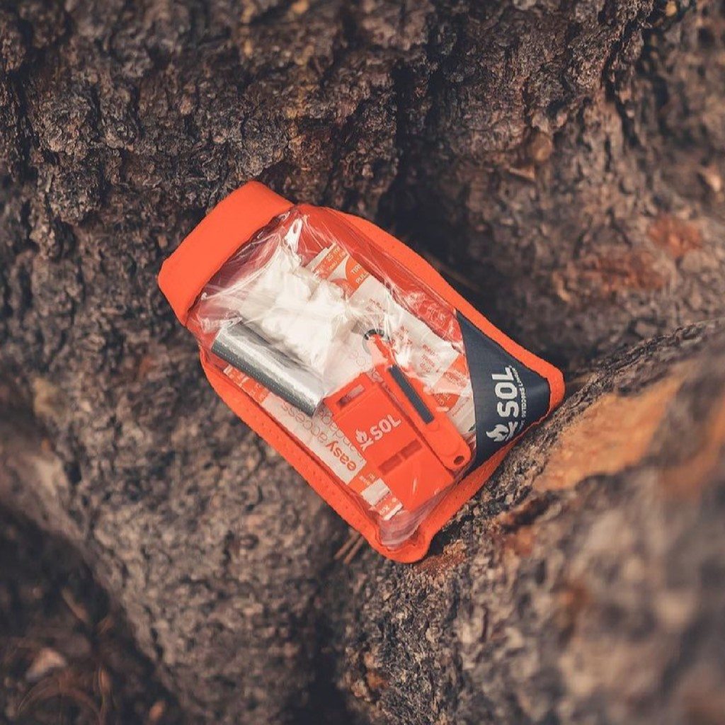 Scout Survival Kit laying on tree