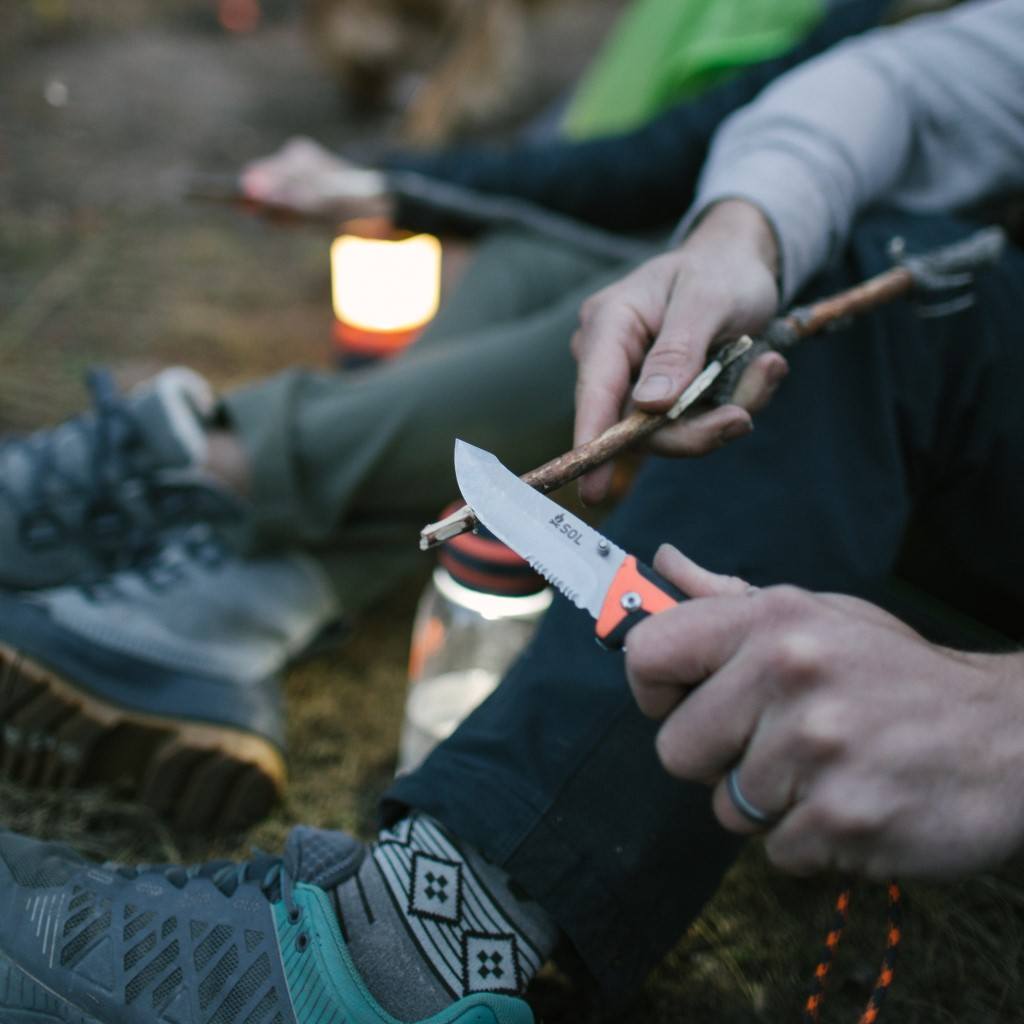 Stoke Folding Knife using knife to sharpen tip of stick while camping