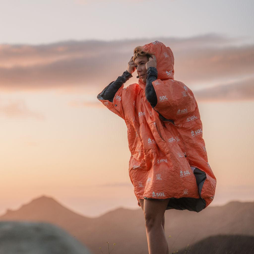 Escape Insulated Poncho woman wearing poncho and hood outdoors