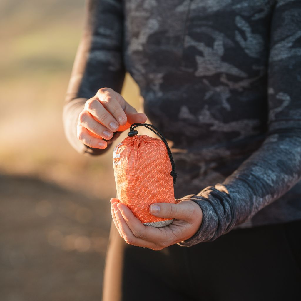 Escape Insulated Trail Seat woman holding stuff sack