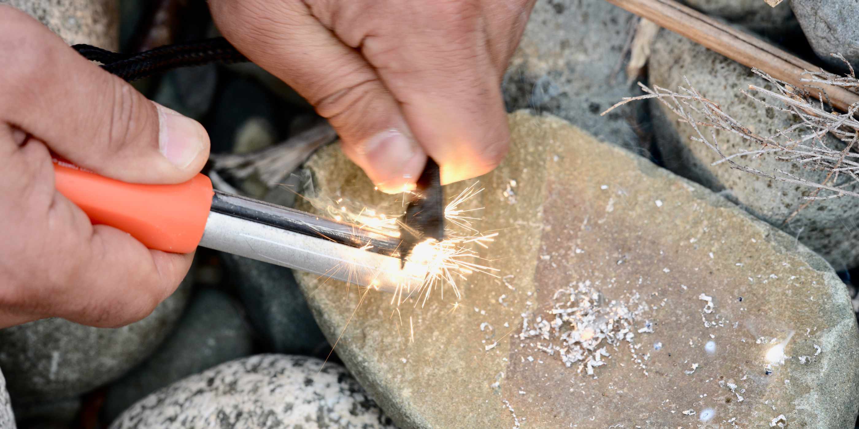 Person Using SOL Mag Striker Striking Sparks Onto a Rock