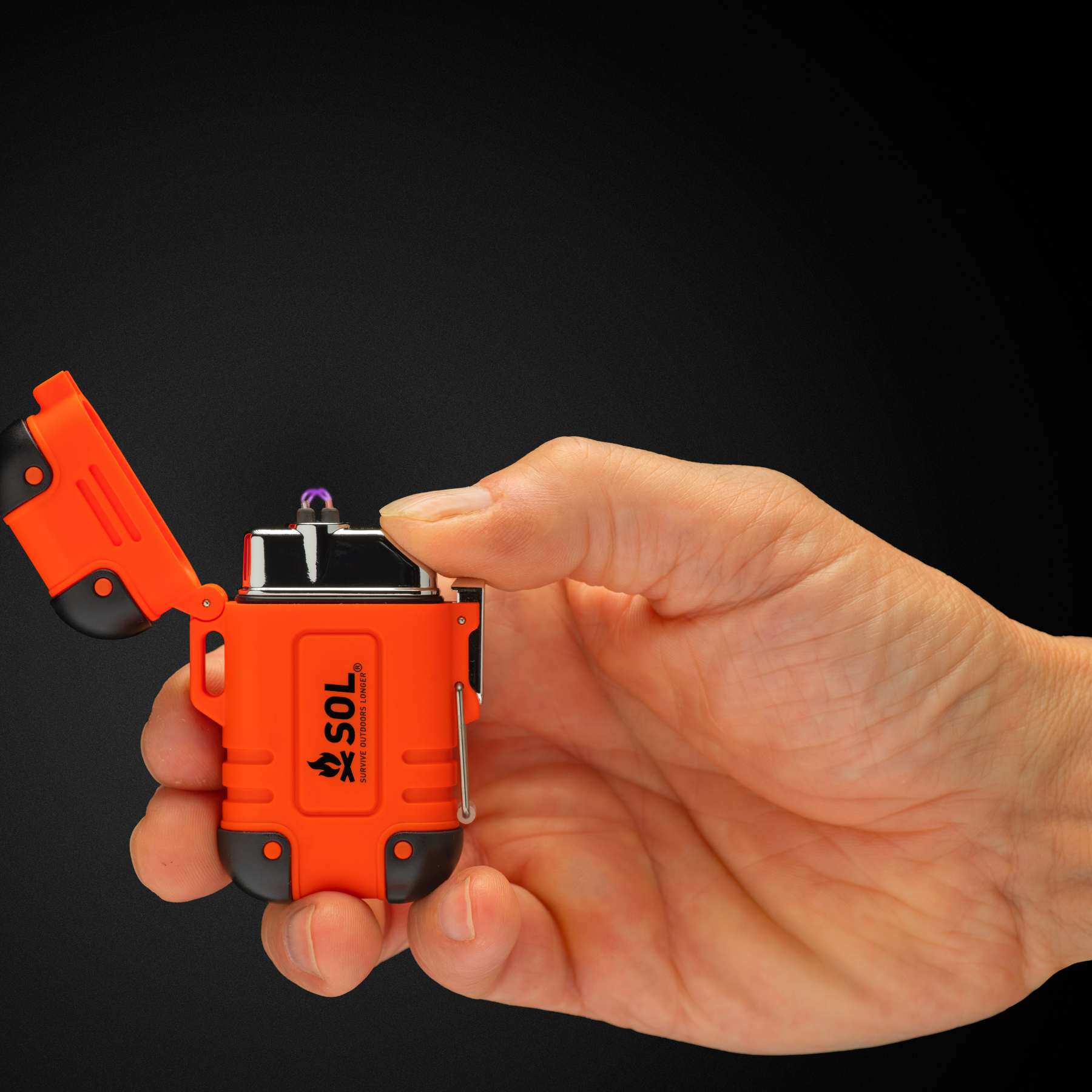 Orange and Black SOL Plasma Dual Arc Lighter in Hand Lit Against Black Background