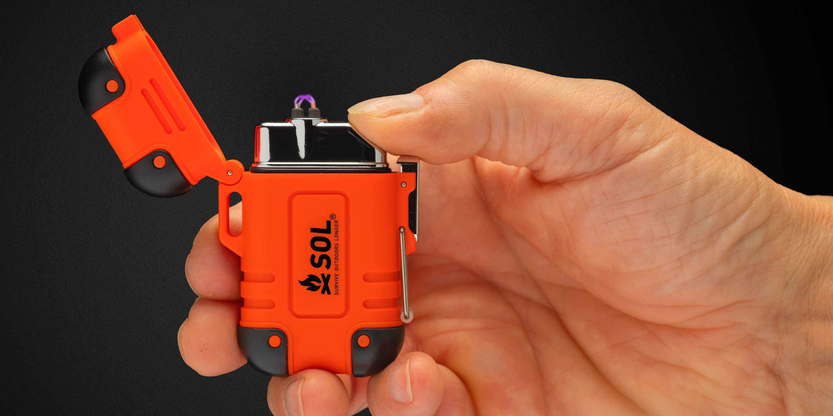 Orange and Black SOL Plasma Dual Arc Lighter in Hand Lit Against Black Background