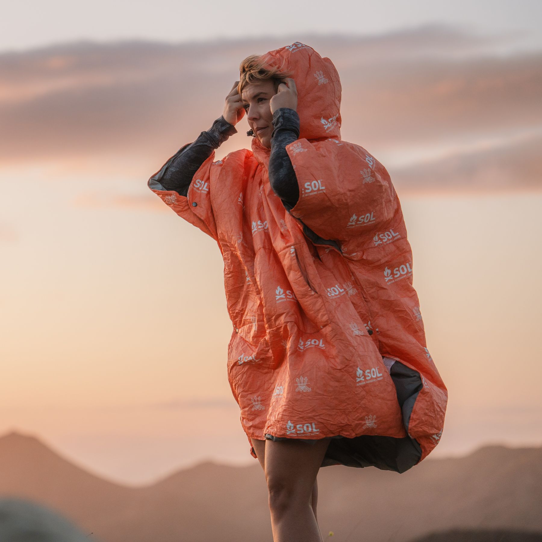 Woman outdoors wearing Escape Insulated Poncho