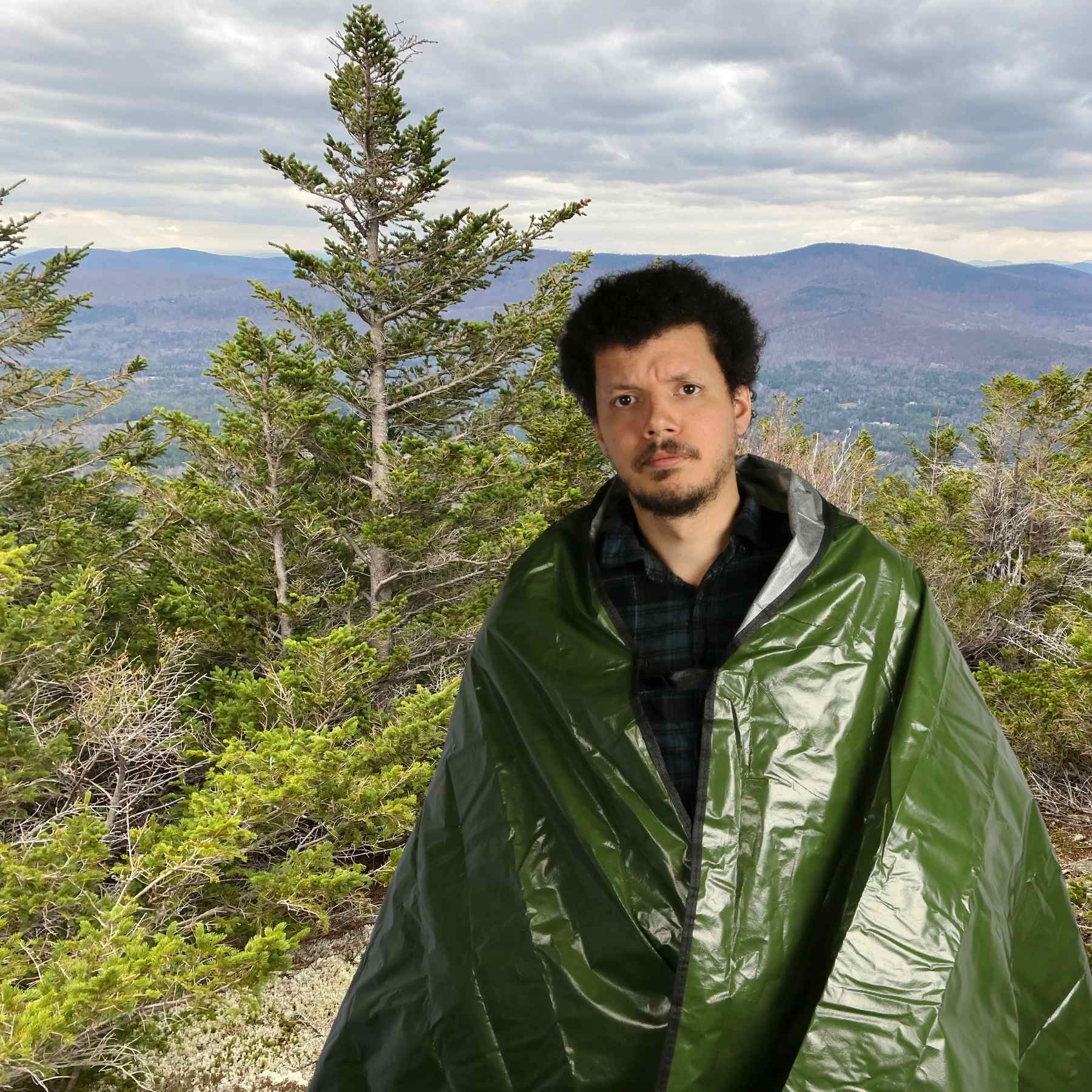 Sport Utility Blanket man wrapped in blanket on summit