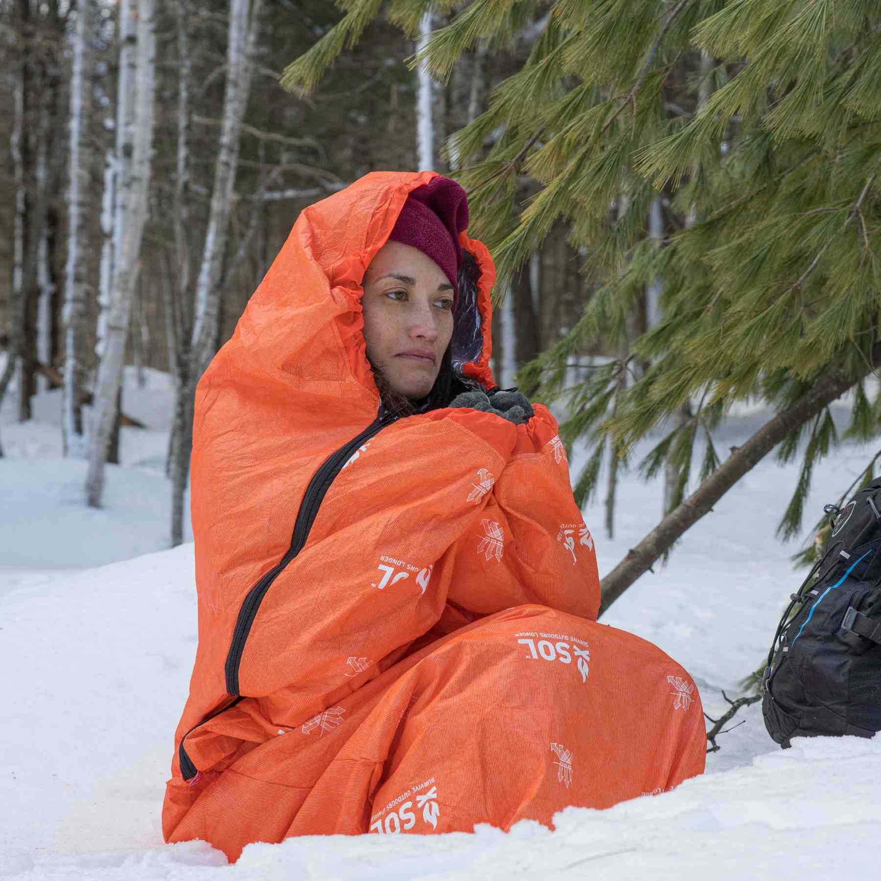 Escape Bivvy Orange woman sitting in bivvy in snow