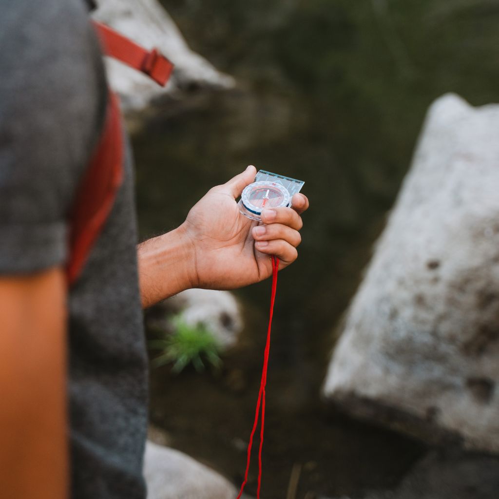 Camp Ready Survival Kit man holding compass