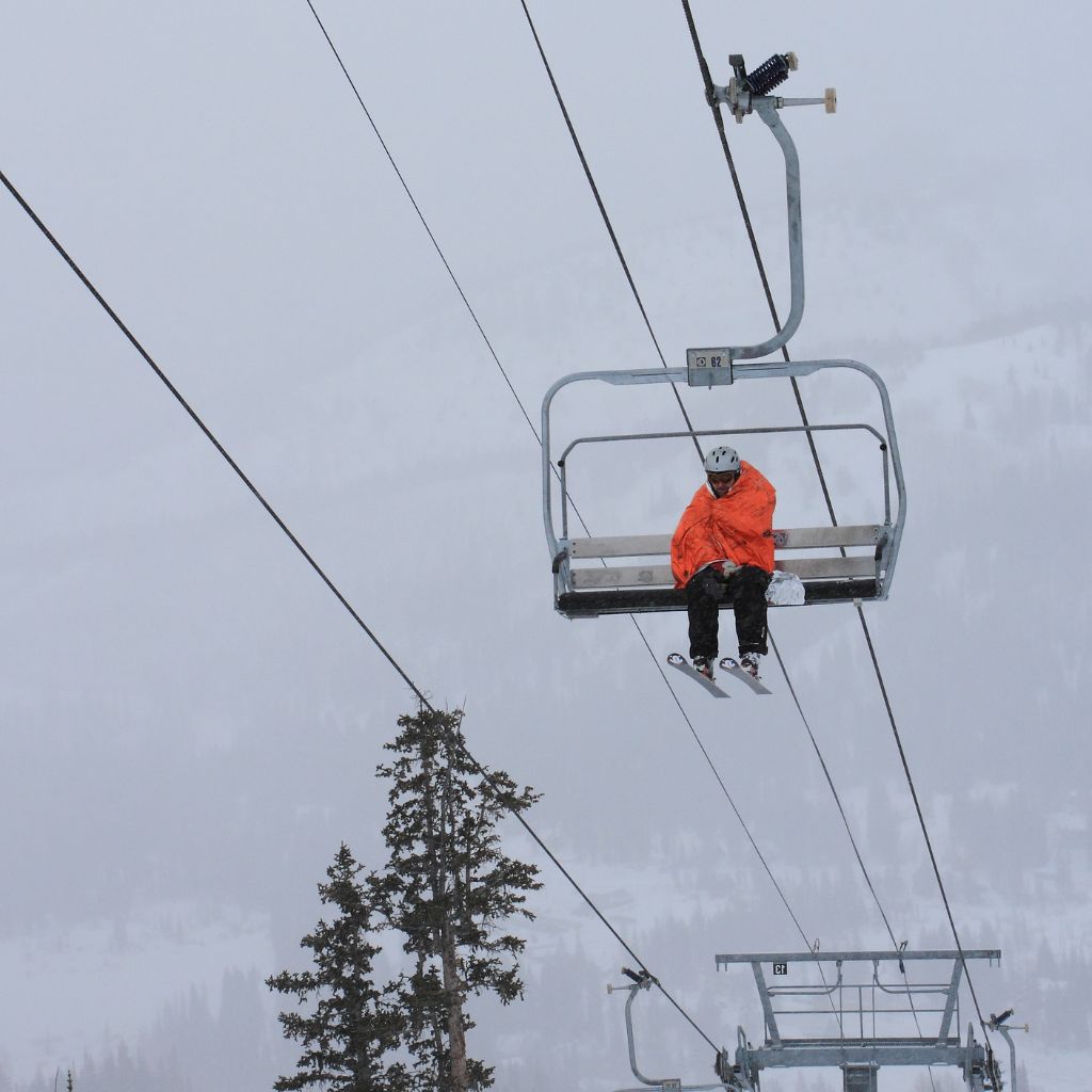 Emergency Blanket XL man on chairlift wrapped in blanket