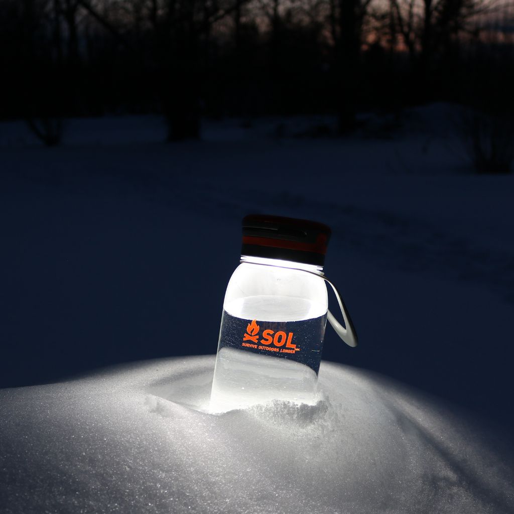 Venture Solar Water Bottle Lantern lit up in snow