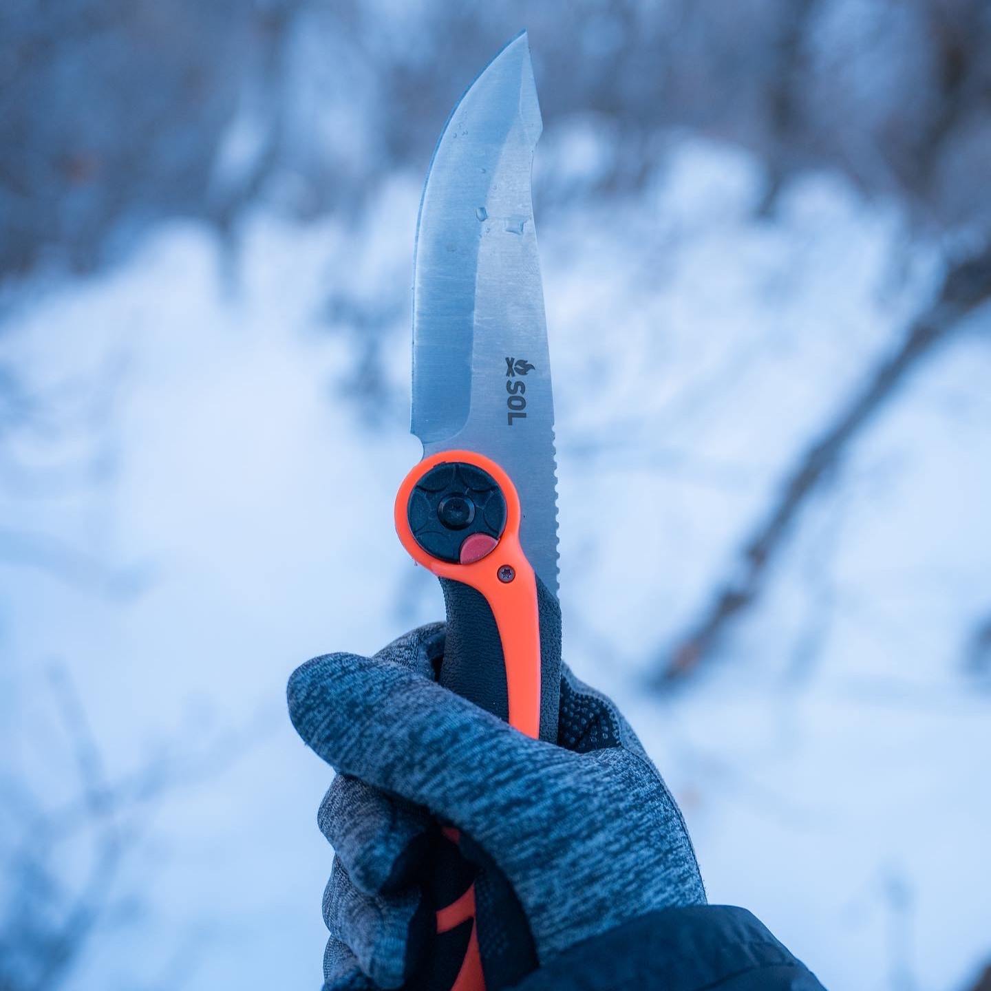 Stoke Pivot Knife & Saw holding opened knife in winter with glove on hand